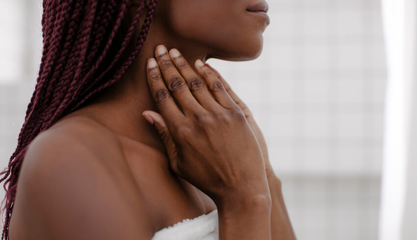 A woman staring at her reflection in the mirror
